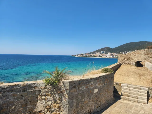 Illustrative island coast and Mediterranean water